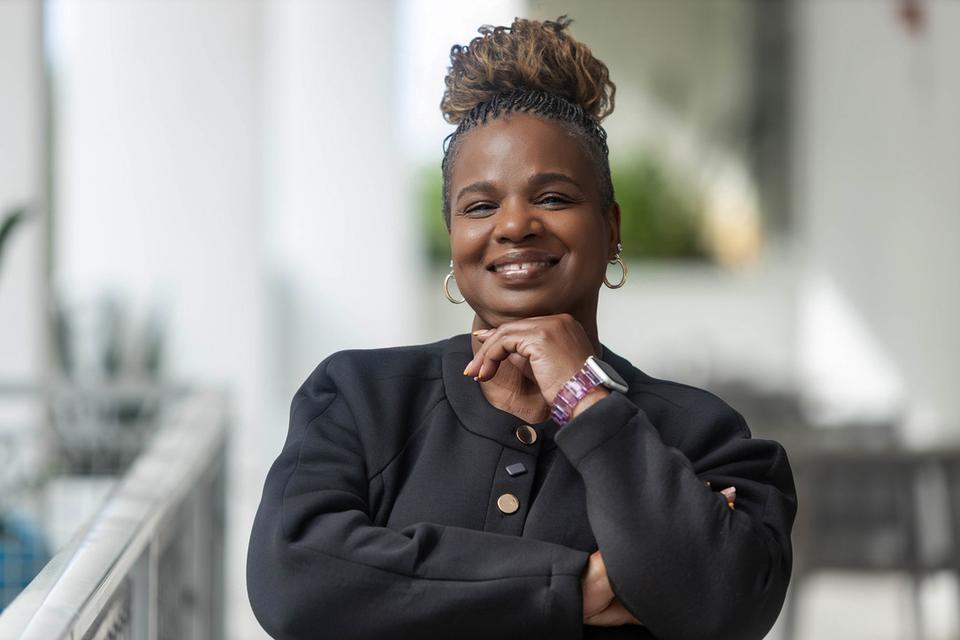 Susan L. Peterkin smiling, arms folded, in a black jacket.
